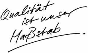Handgeschriebener Text in fließendem Stil: "Qualität ist unser Maßstab" in Schwarz.